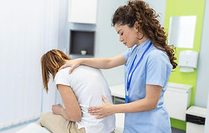 physiotherapist-doing-healing-treatment-womans-back-back-pain-patient-treatment-medical-do