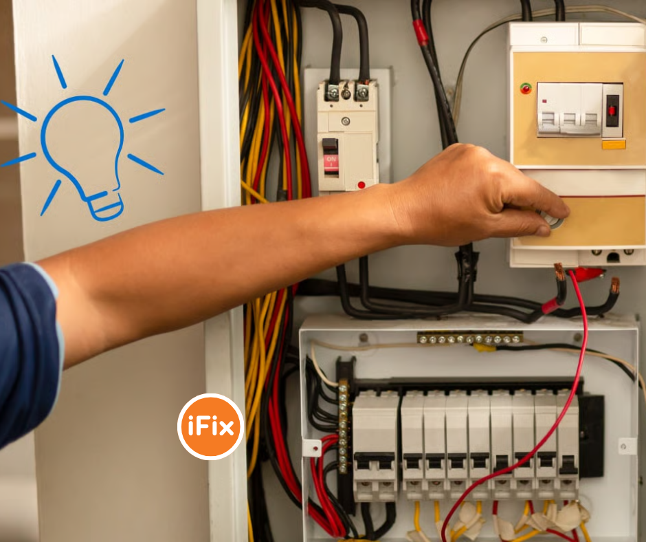 A person's hand adjusting a circuit breaker inside an open electrical panel with colorful wiring, accompanied by a blue lightbulb icon and the iFix logo.