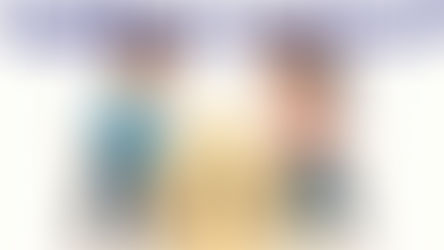 Two people hugging and their dog is frowning