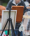 Process of plein air painting, group class of adult talented students in the park with pai
