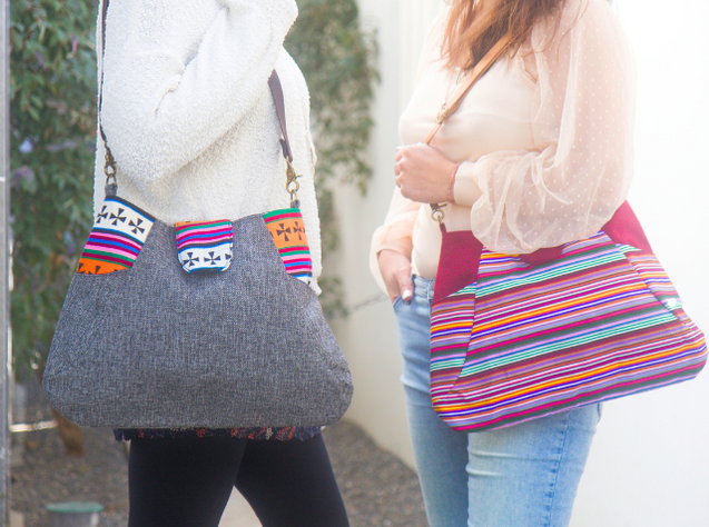 Two women with multi-colored tote bags