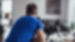 blurred image looking over the shoulder of a photographer taking interior real estate phot