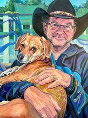 Man wearing cowboy hat holding mixed-breed rescue dog on a lake home patio