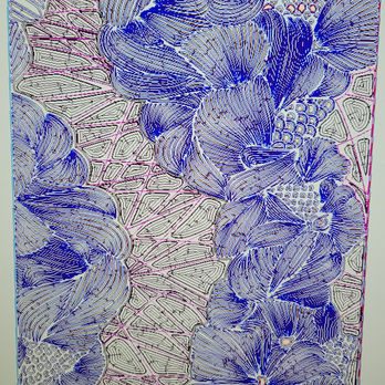 Large illuminated floral relief sculpture featuring layered botanical forms carved into a contemporary architectural wall panel.