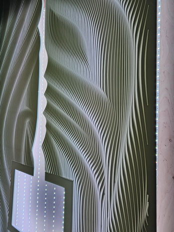 Perspective view of sculptural illuminated relief fireplace wall at Tuscan Café.