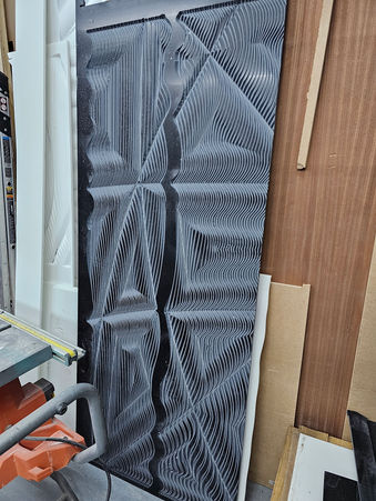 Close-up of Rilievo 3D textured surface during fabrication showing material depth and sculptural detailing