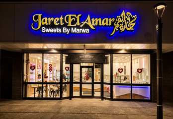 Custom illuminated CNC relief counter and sculptural ceiling feature at Jaret El Amar Sweets designed by RILIEVO.