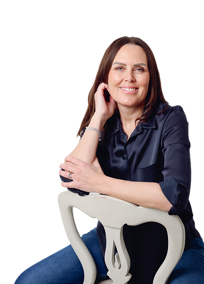 Portrait of Amanda, founder of Willow & Birch, sitting against a white background wearing a blue blouse and jeans, representi
