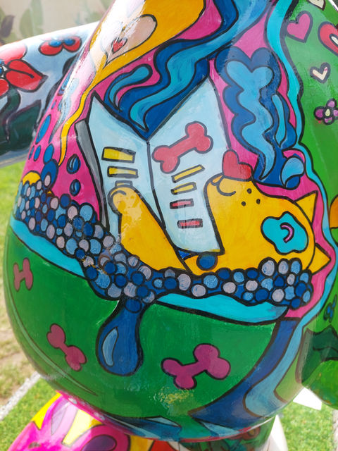 Close up of Self-Care with Snoopy showing a yellow doc enjoying a bubble bath on the Snoopy sculpture's tummy.