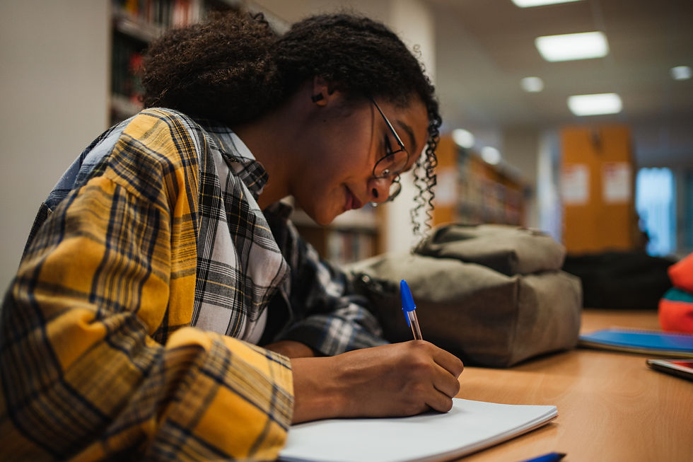 Eye-level view of a student studying with a laptop and books