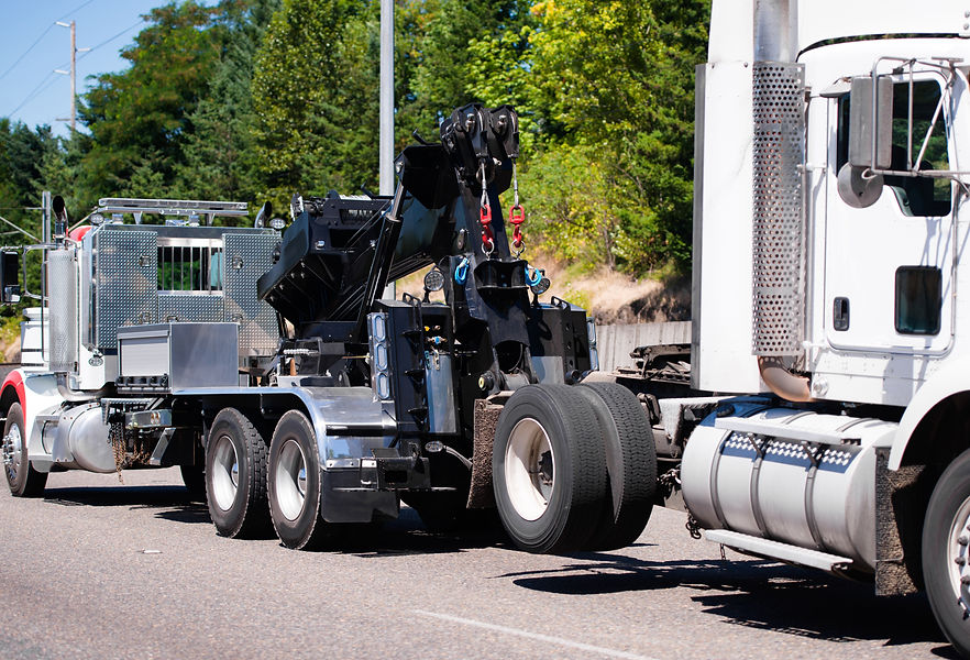 Un camion transporte un véhicule poids lourd