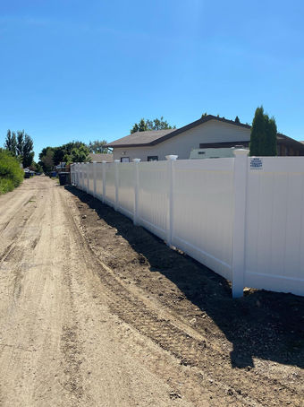 A view of a white fence from the outside