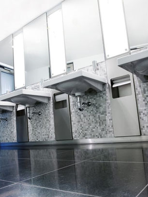 Modern public restroom with integrated paper dispensers, ideal for IoT based hygiene monitoring