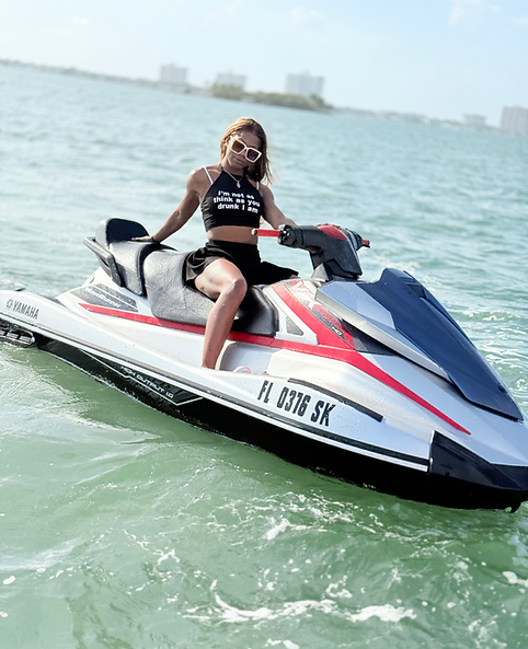 Rider enjoying jetski on crystal-clear Miami waters during sunny day