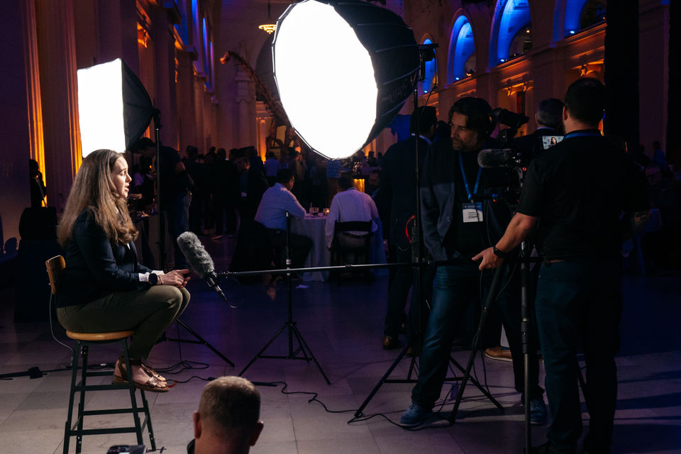 Woman interviewed with video lights and camera crew at Augeo Ford Pro Event at Field Museum in Chicago