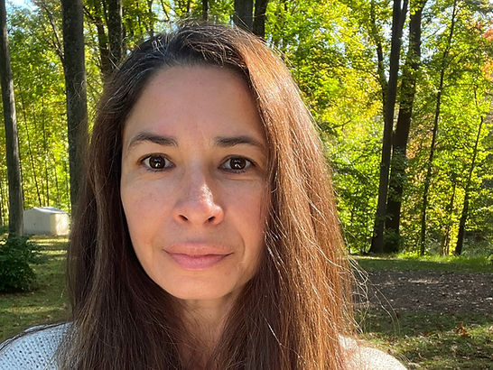 Karla Levitt in woods holding phone and taking selfie