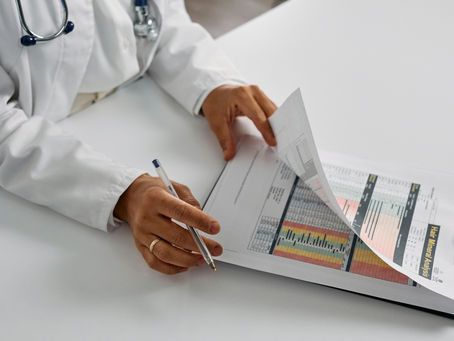 Doctor reviewing preventive healthcare analysis and patient health data to support early intervention and long-term care.