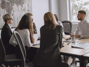 Team collaborating independently in a meeting, representing sustainable leadership and resilient team performance.