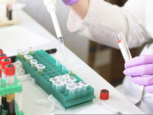 Scientist using a pipette to handle laboratory samples during medical research, representing the FDA approval process and clinical testing.