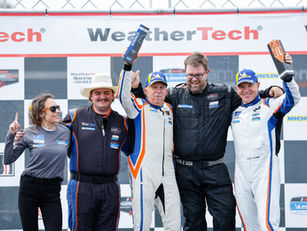 Ted Giovanis and Team TGM celebrating a Bronze class victory on the podium after the IMSA Michelin Pilot Challenge race at WeatherTech Raceway Laguna Seca.