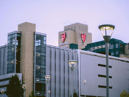 Exterior view of a large university hospital building, representing the economic and community role of hospitals in healthcare policy discussions.