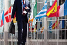 People Walking to Work. Flags with European Parliament in Brussels..jpg