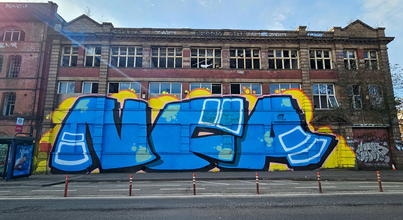 Very large coloured graffiti lettering, on the side of an abandoned building, that says NFA