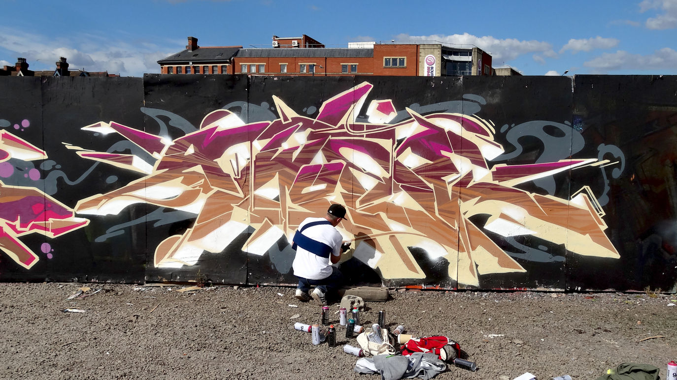 Graffiti artist writer Awone painting one of his pieces of art