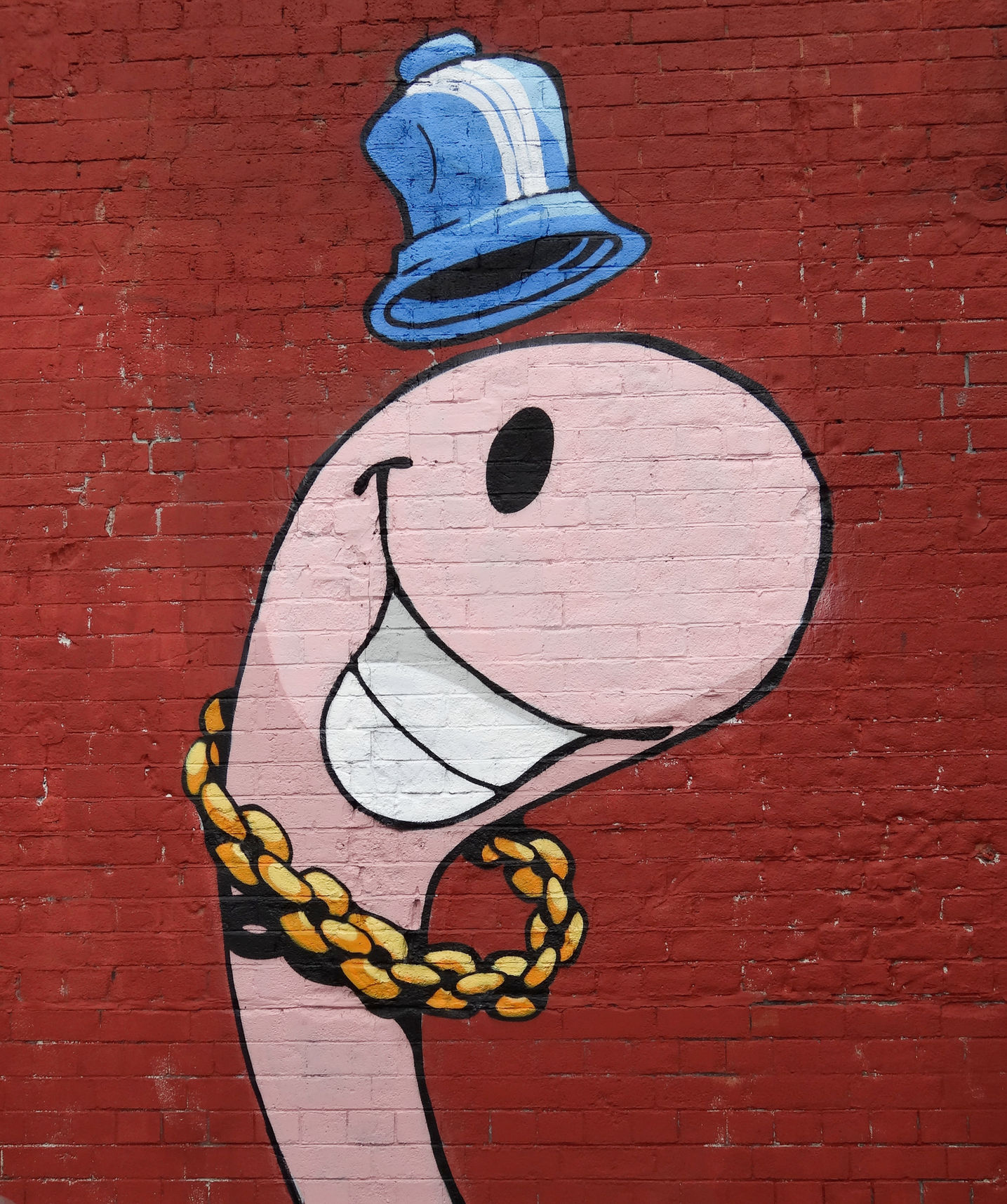 A graffiti character of a hip hop looking worm wearing a hat and a gold chain