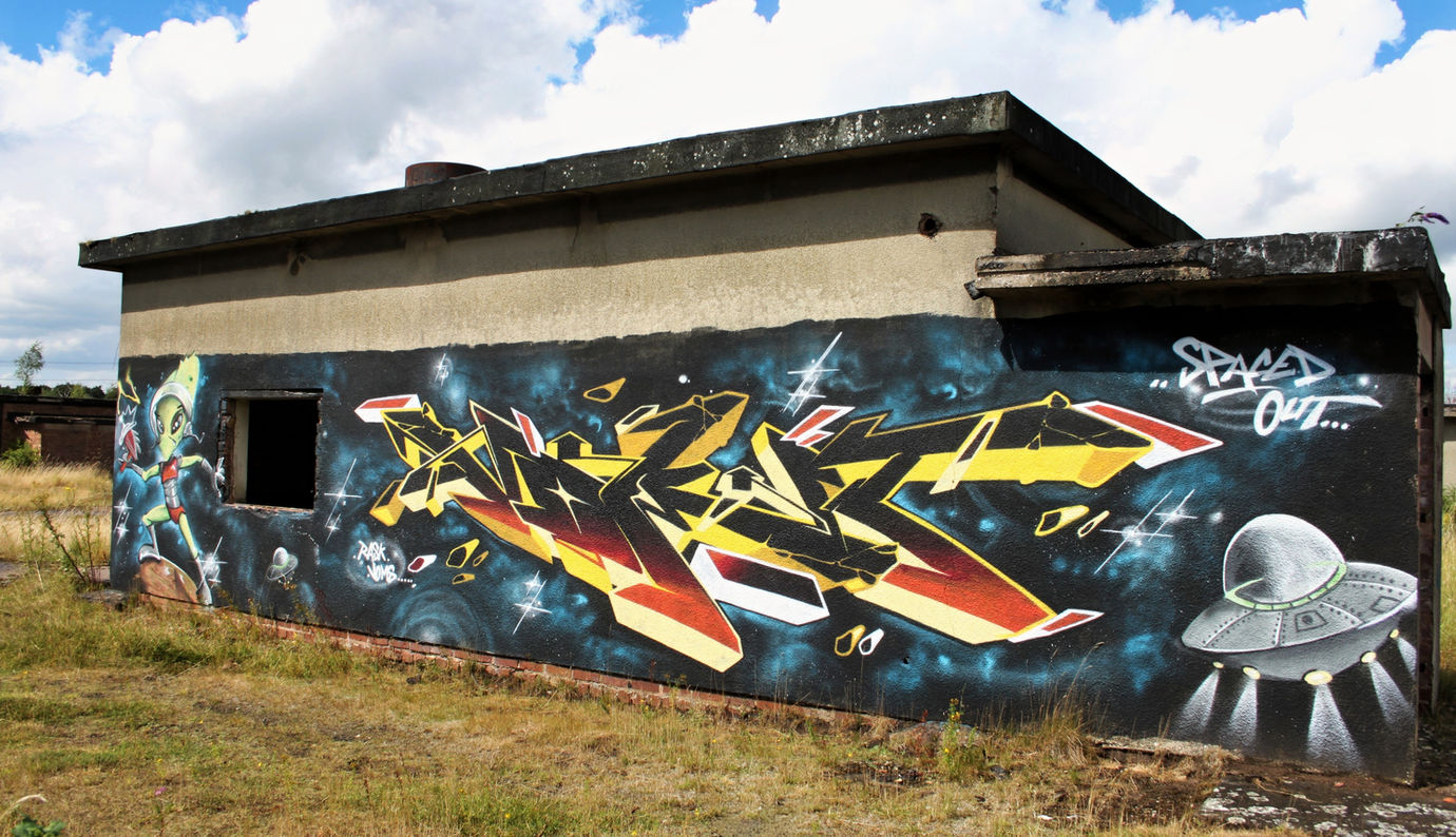 "Spaced Out" alien inspired wall of graffiti featuring the character of an alien and a UFO painted by writer artist Vomit NFA and Rask HBR
