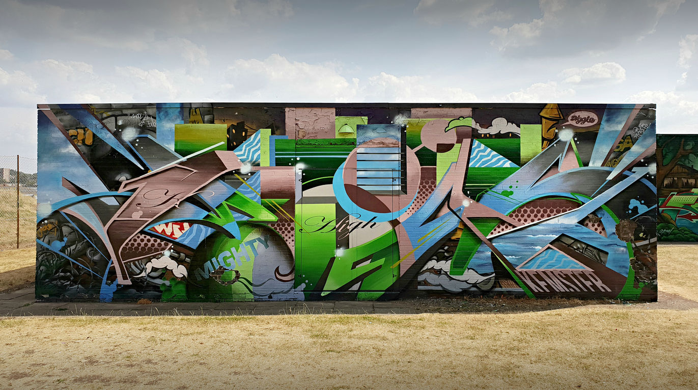 Abstract graffiti letters spray painted a decent sized wall