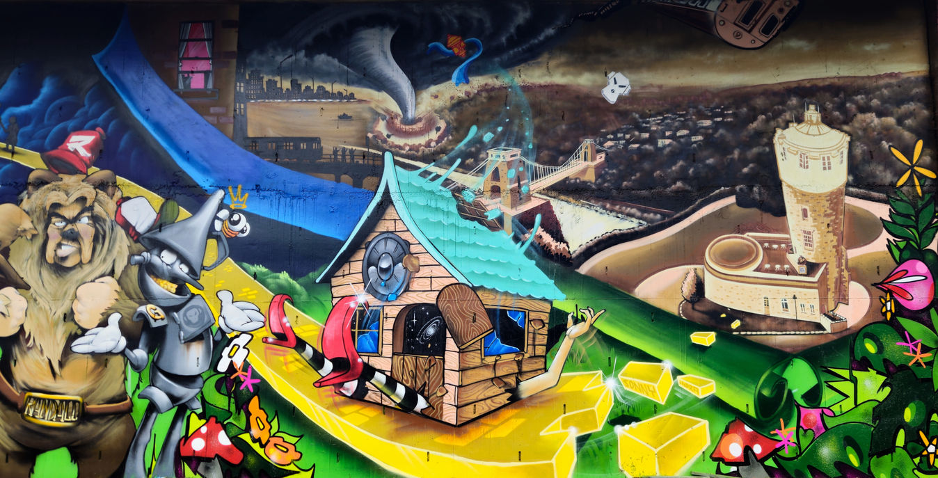 The Wizard Of Oz film themed graffiti wall featuring landmarks in Bristol, UK