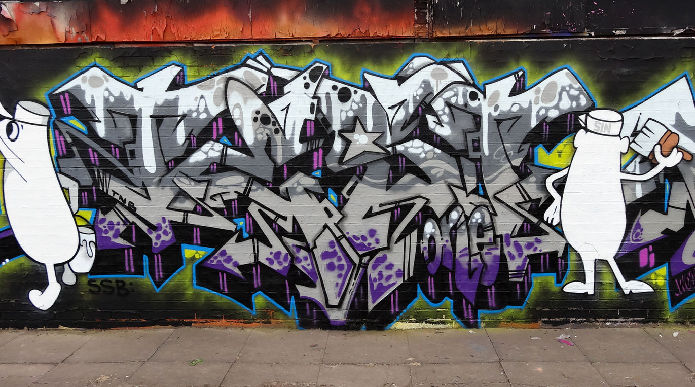 Wildstyle graffiti letters featuring two white coloured characters
