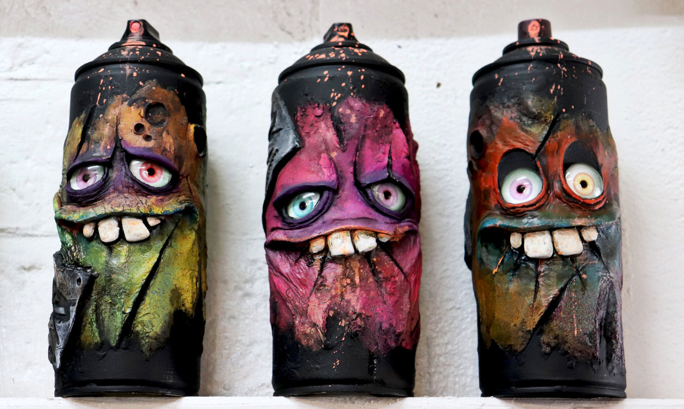 Clay sculpted spray cans with eyes and goofy big teeth