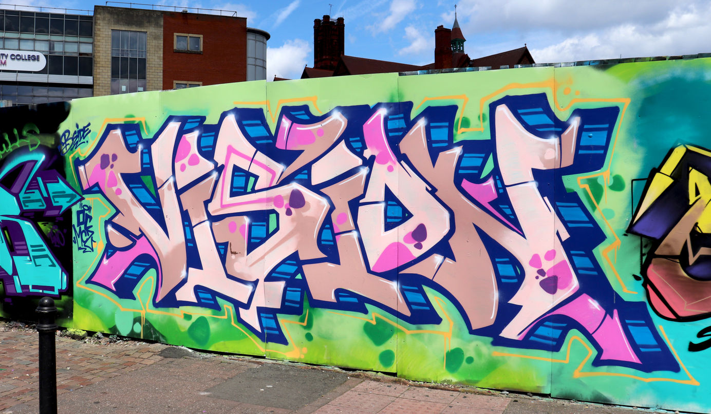 3d graffiti lettering that is coloured pink, blue and brown and painted by writer artist Vision