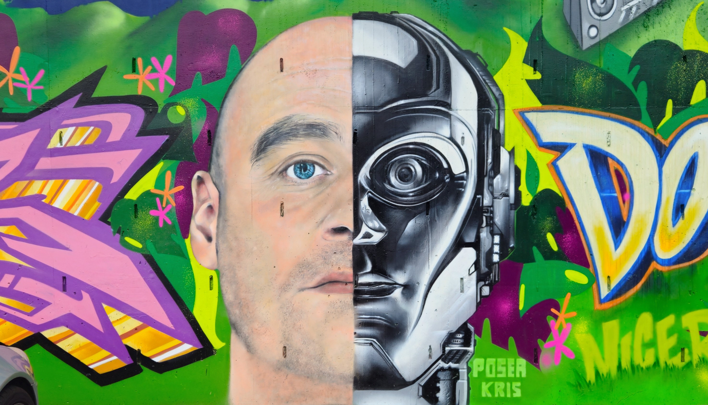 spray painted image of a man's face where half is human and the rest is robotic