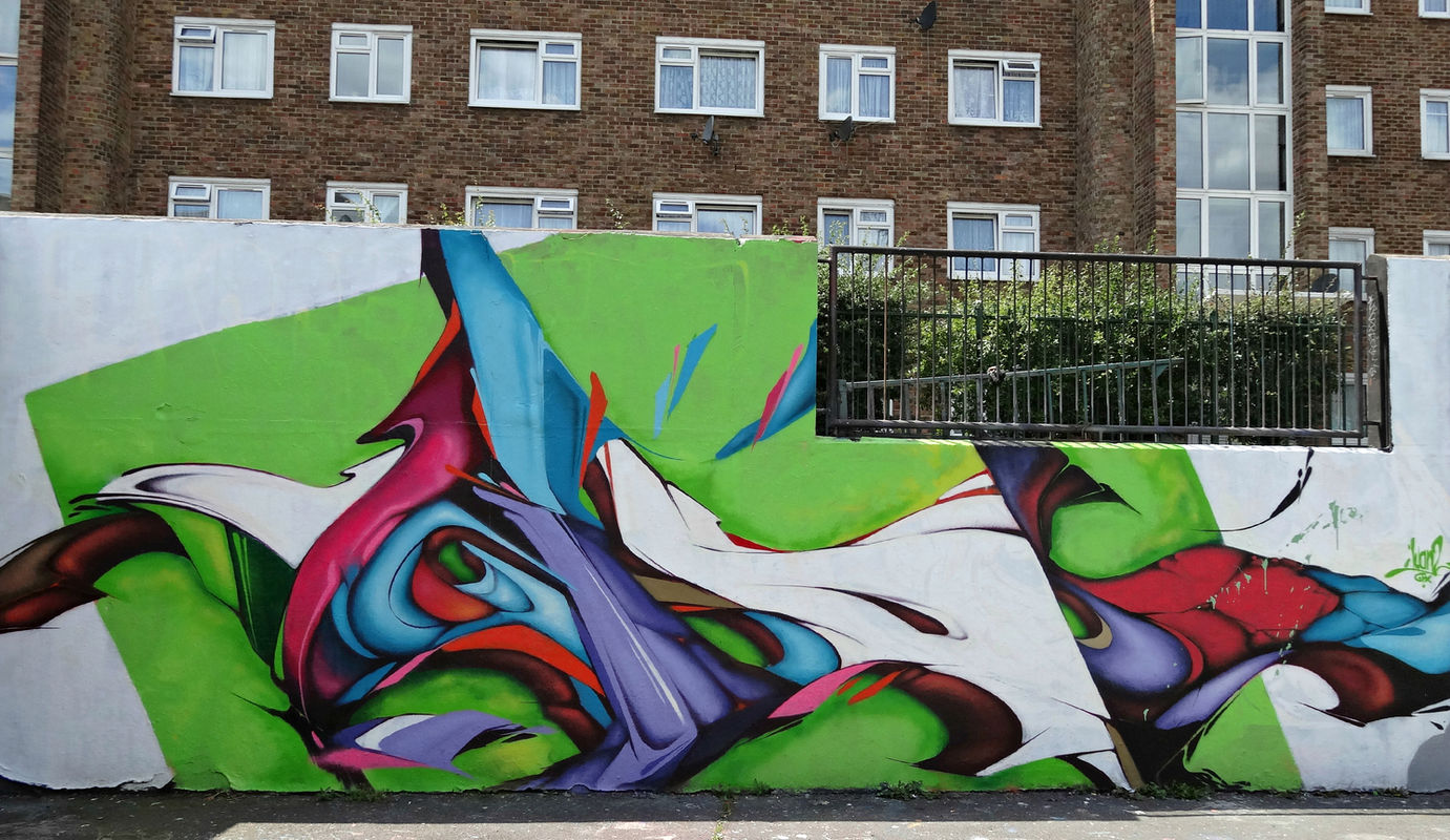 A very abstract piece of graffiti art featuring the colours blue, red, white and green