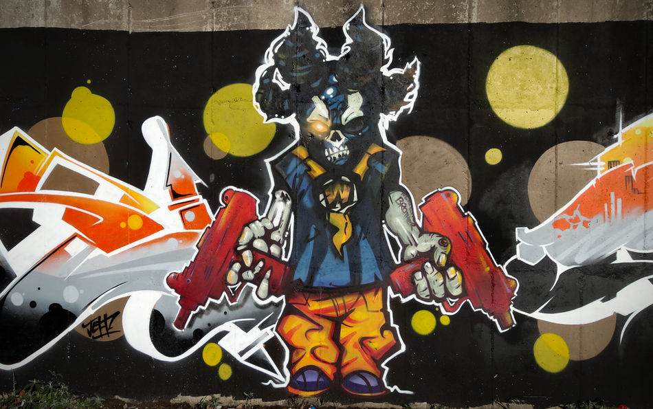 A graffiti character of a zombie holding two machine guns