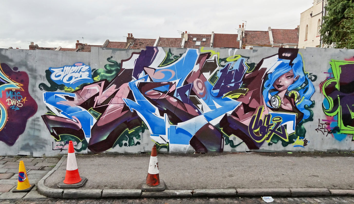 Graffiti letters painted with style including a character with blue hair