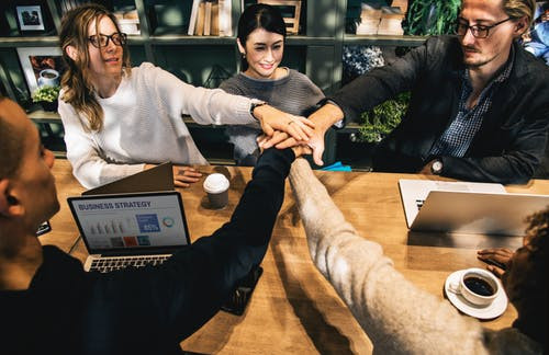 Group of young adults hands in the middle