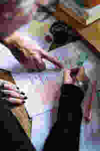 Two sets of hands reviewing a document
