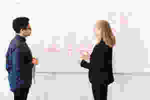 man and woman at a whiteboard