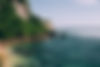turquoise-blue-ocean-waters-along-jungle-covered-cliffside.jpg
