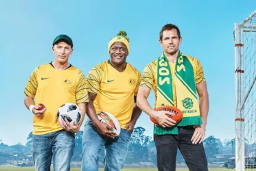 Three men in Australian sports jerseys holding balls, celebrating national sports culture and team spirit.