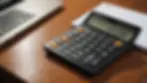 A close-up view of a calculator on a wooden table