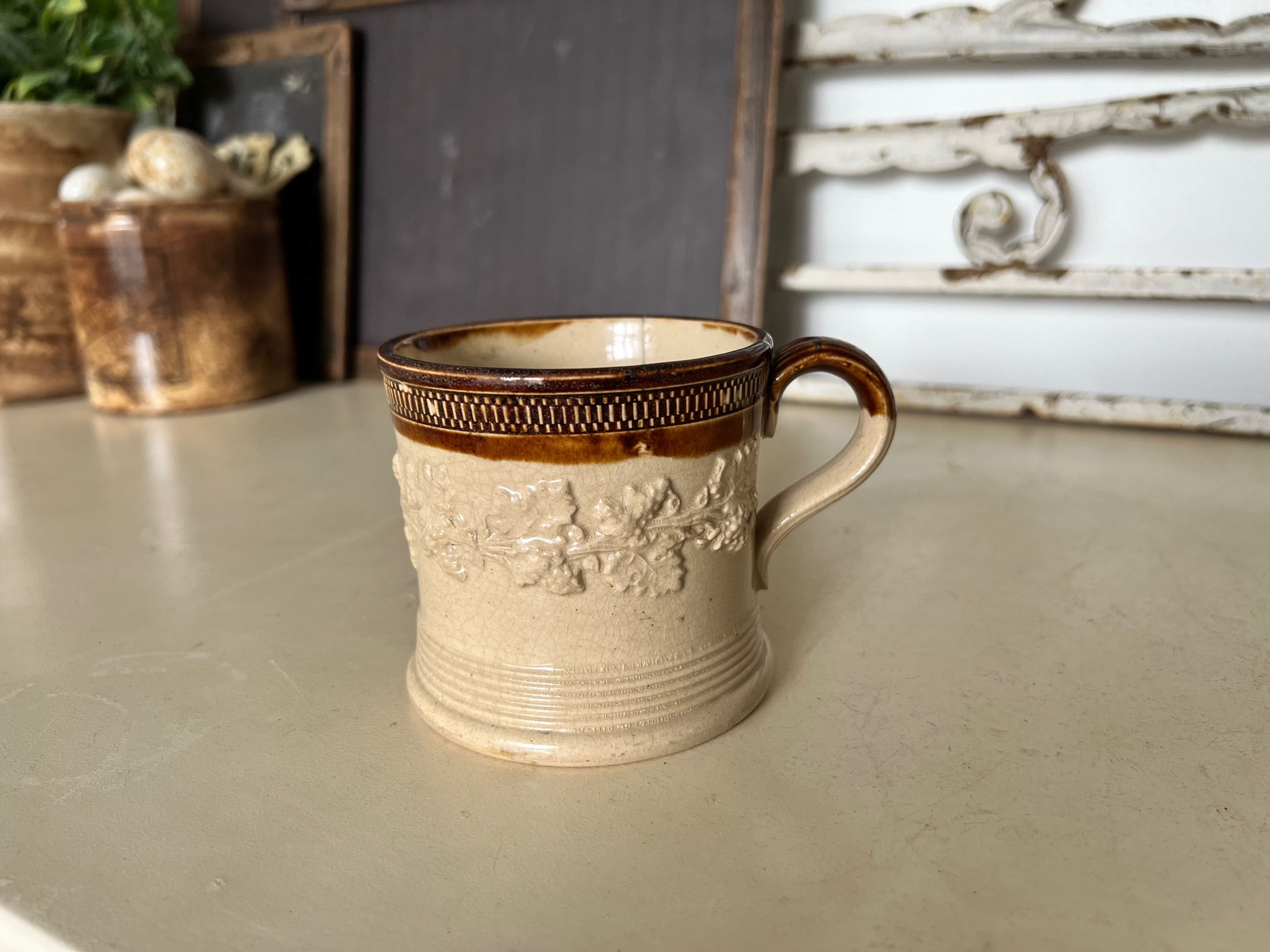 Antique salt glazed mug with relief grapes