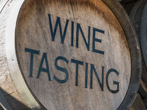 Image of a wine cask with the wording "wine tasting" printed on it.
