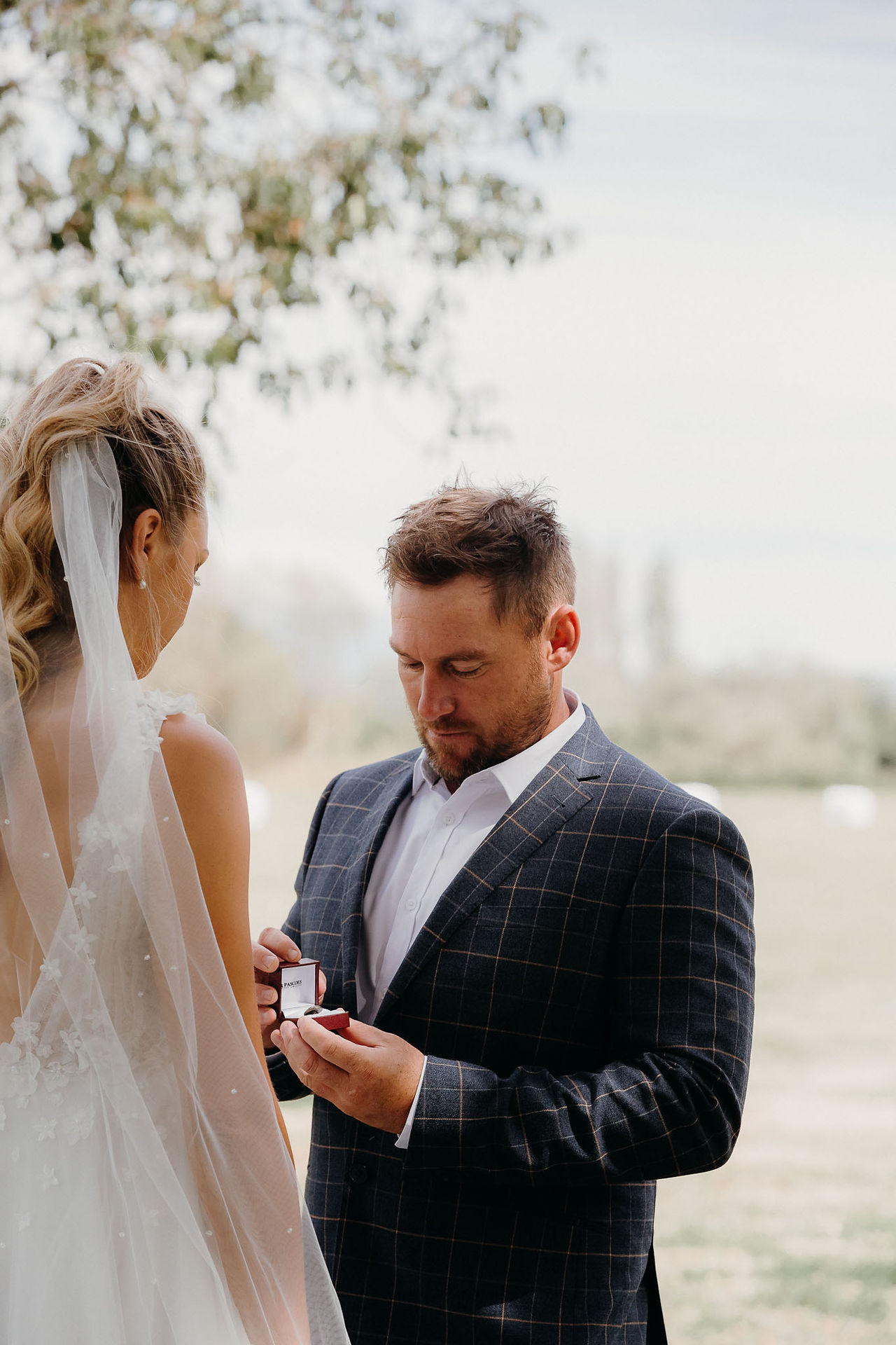 Bride giving the groom a memorial pin before their Canterbury wedding