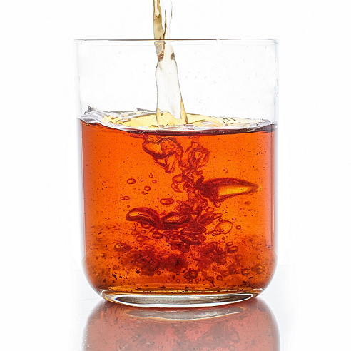 Thumbnail: golden tea being poured into a glass, with bubbles rising to the surface, capturing the freshness and clarity of the drink.