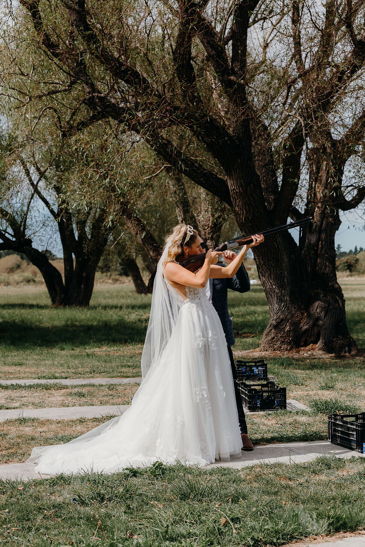 Bride and groom clay bird shooting with their bridal party before the wedding ceremony